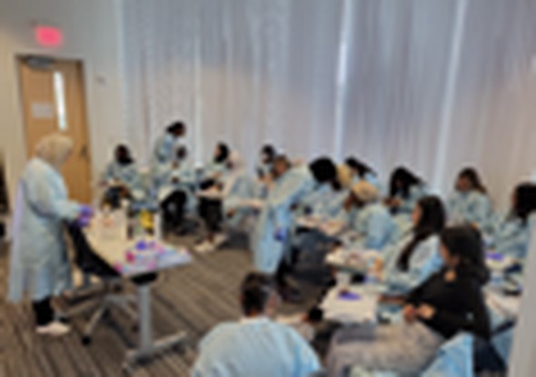 M. Nasiri mentoring K-12 students in a hands-on synthetic biology workshop, summer 2023
